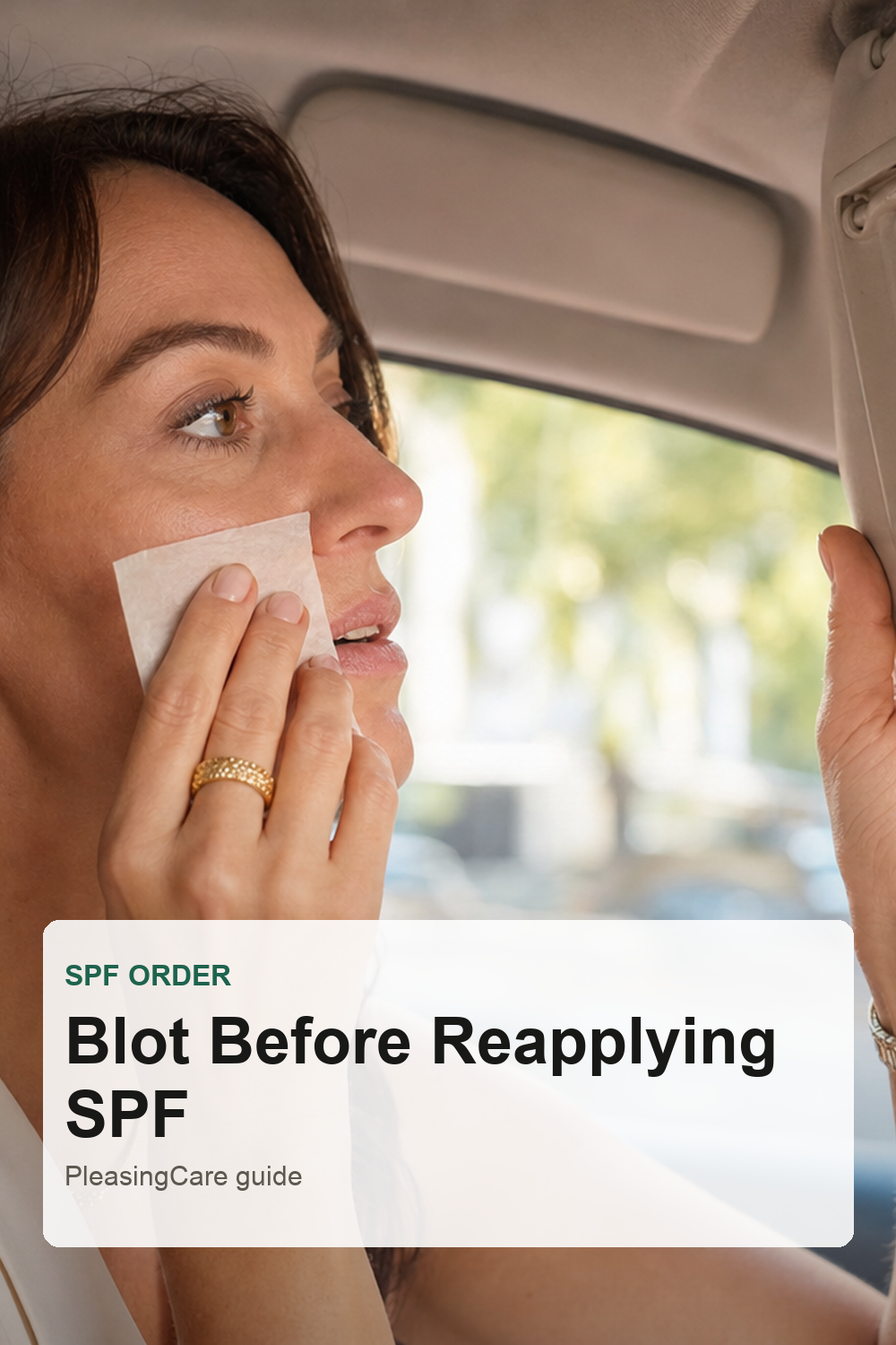 Woman blotting oily skin before reapplying sunscreen